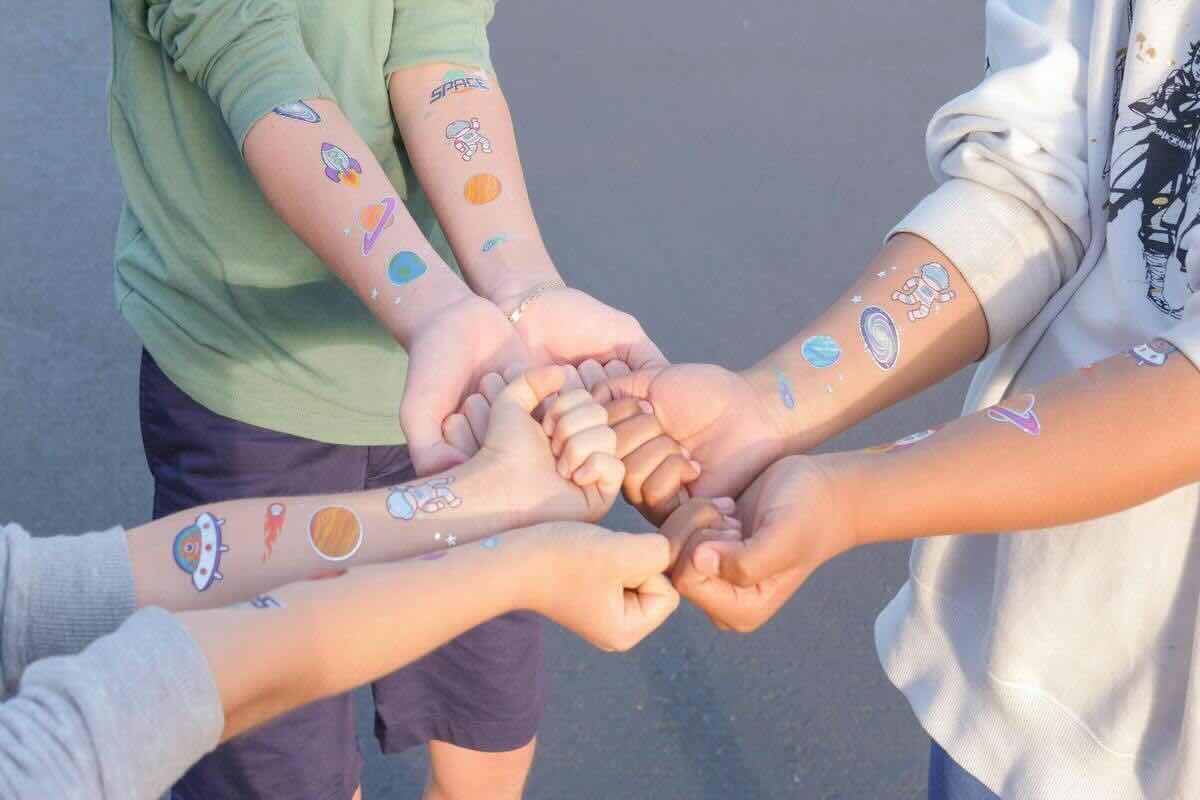 Braccia bambini con tatuaggi